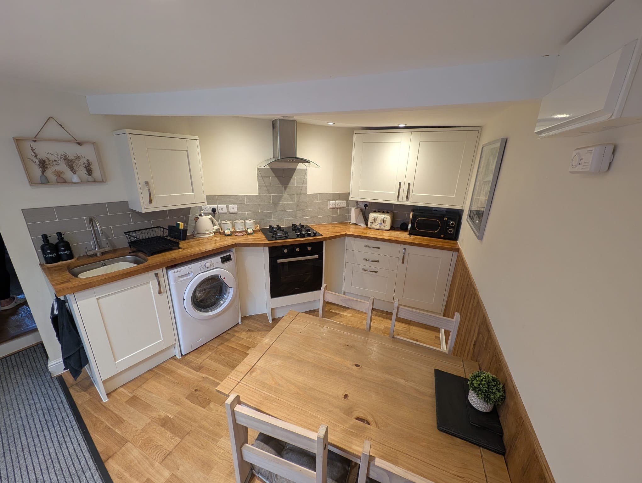 Kitchen/diner with shaker cabinets and dining table